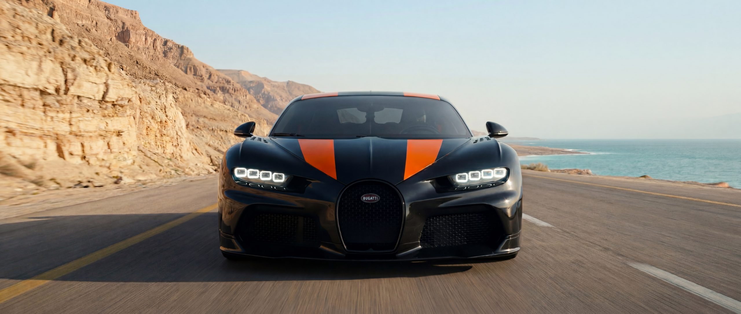 A Bugatti Super Sport 300+ on a desert coast road